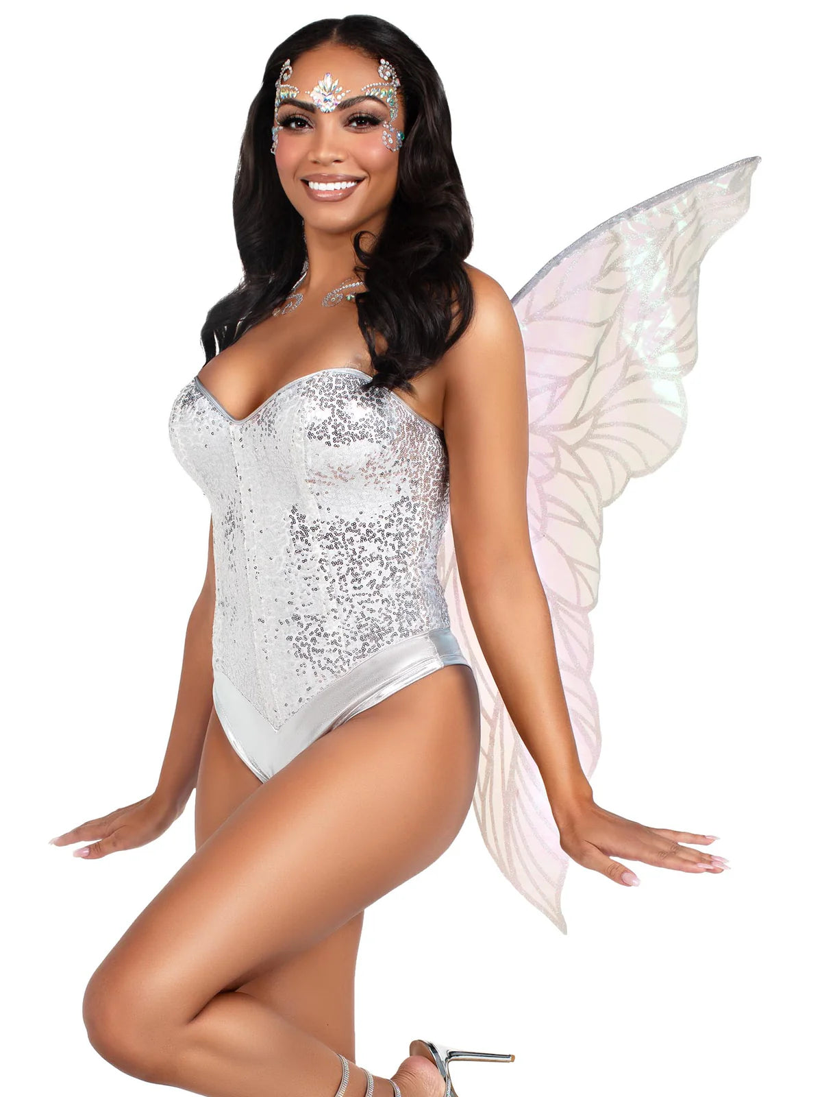 Woman in a silver sequin costume with fairy wings on a white background