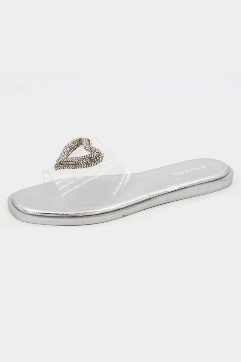 Silver sandal with a decorative heart charm on a white background