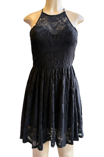 Black lace dress on a mannequin against a white background