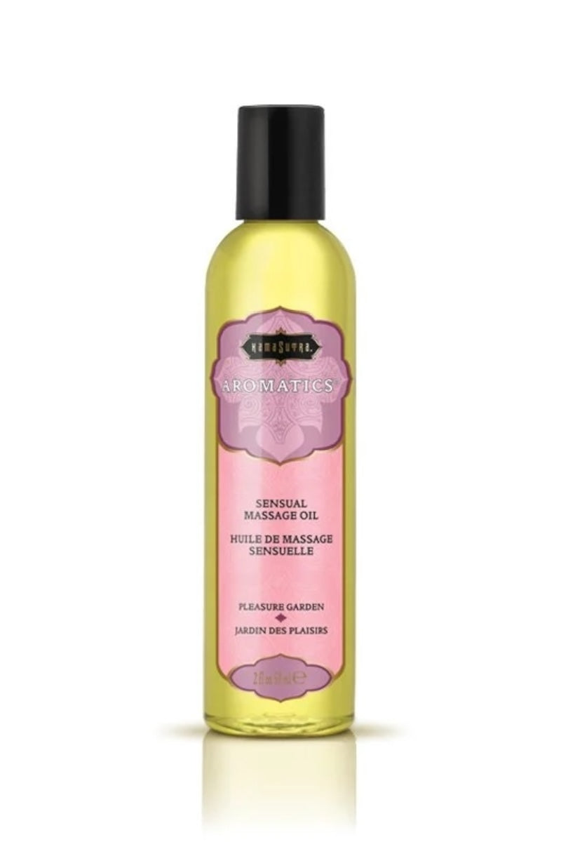 Bottle of massage oil with a pink label on a white background