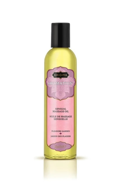 Bottle of massage oil with a pink label on a white background