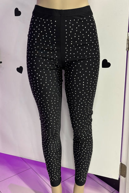 Black leggings with white rhinestone pattern on a white background