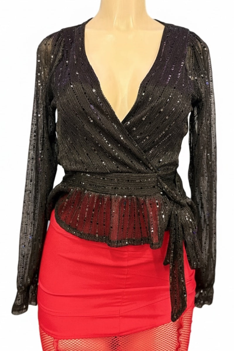 Mannequin wearing a black sequin top and red skirt with fishnet overlay.