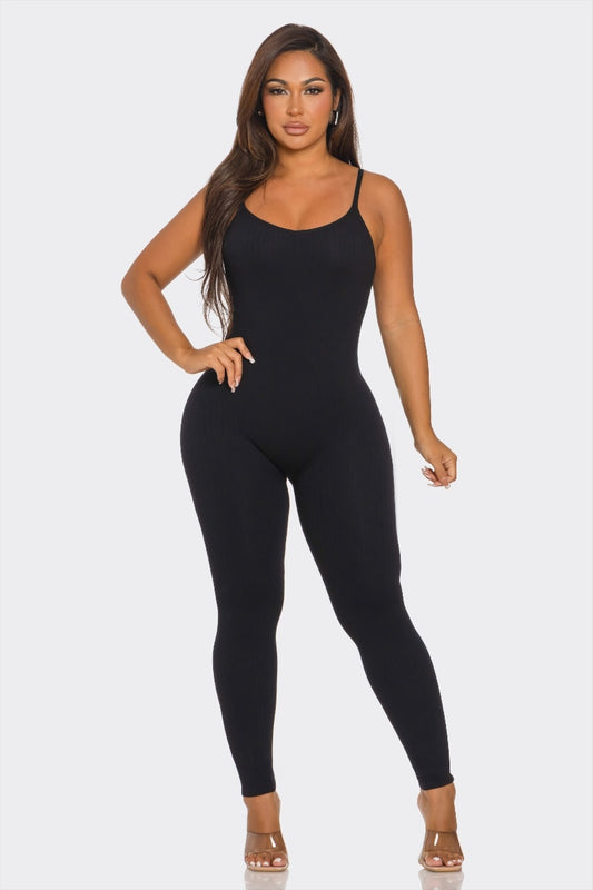 Woman wearing a black bodysuit on a white background