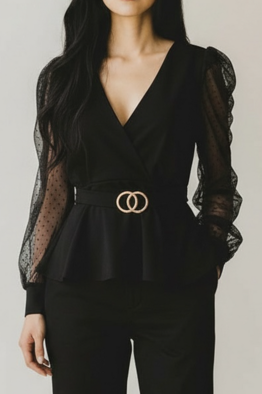 Black peplum top with sheer sleeves and gold belt on a plain background