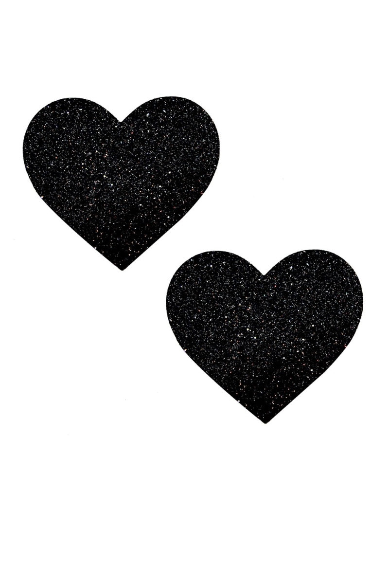Two black heart-shaped pasties on a white background