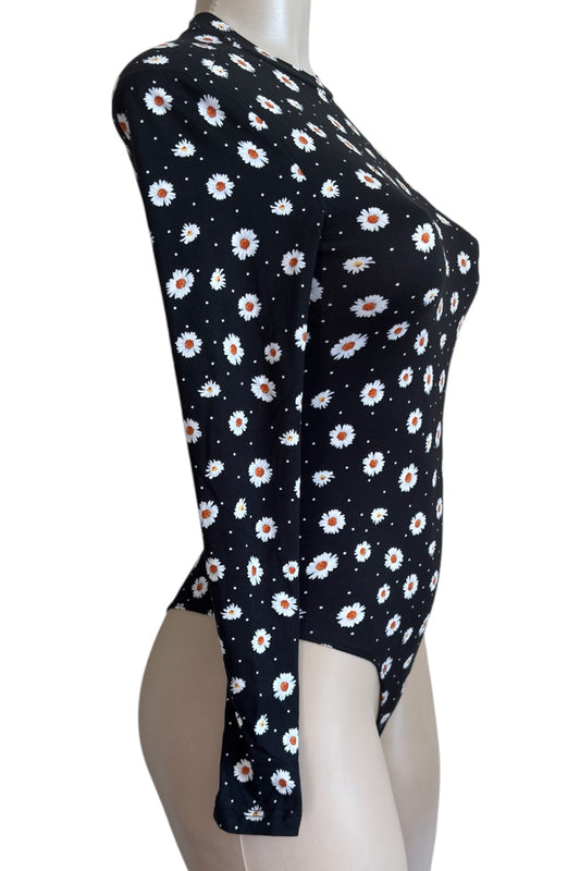 Black blouse with white floral pattern on a mannequin against a white background
