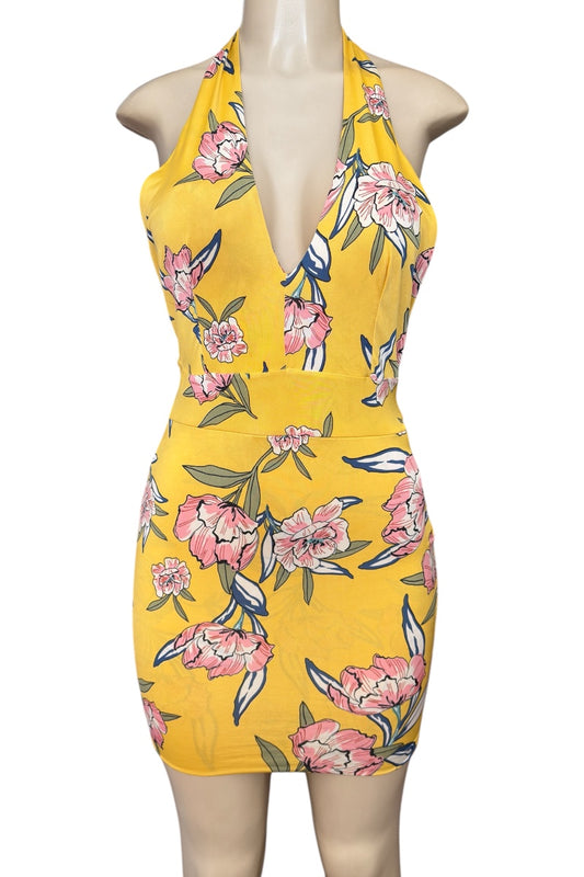Yellow dress with floral pattern on a mannequin against a white background