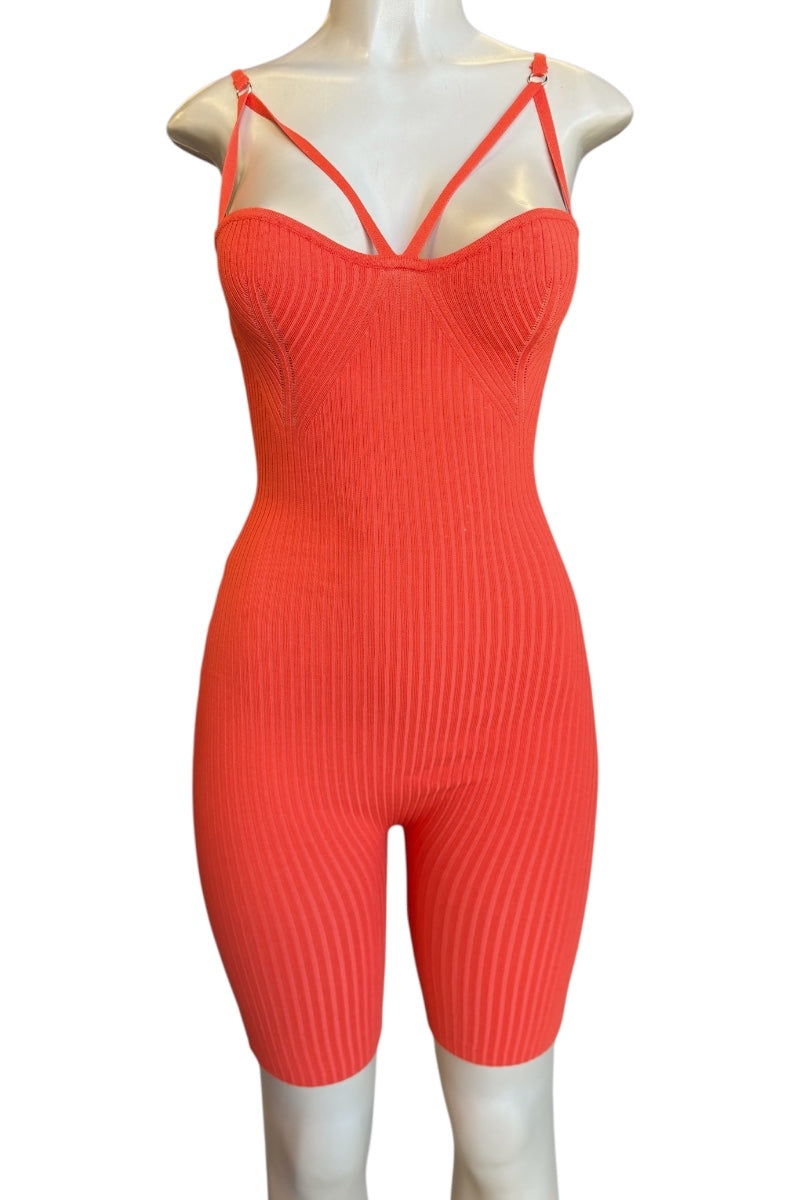 A bright coral-red ribbed knit one-piece jumpsuit with thin double shoulder straps, displayed on a white mannequin against a plain white background.