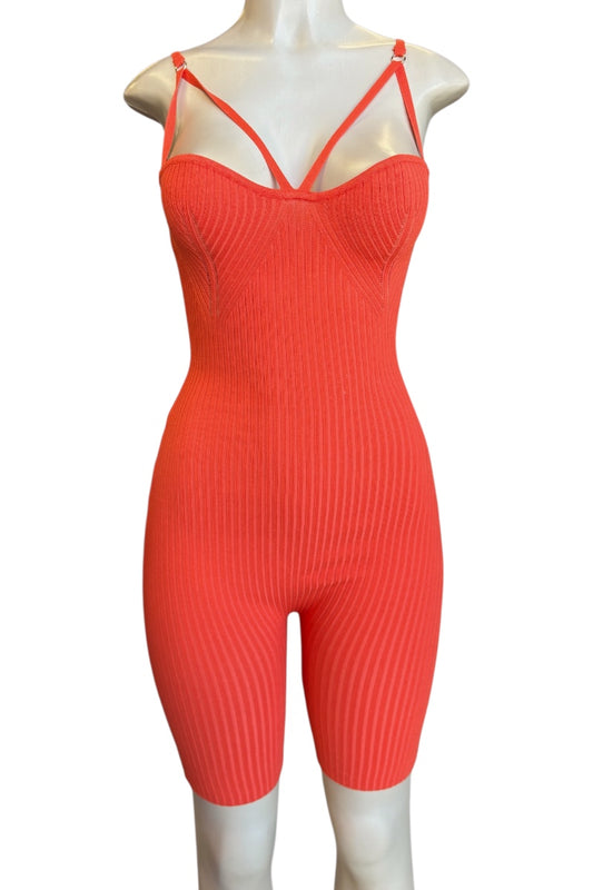 A bright coral-red ribbed knit one-piece jumpsuit with thin double shoulder straps, displayed on a white mannequin against a plain white background.