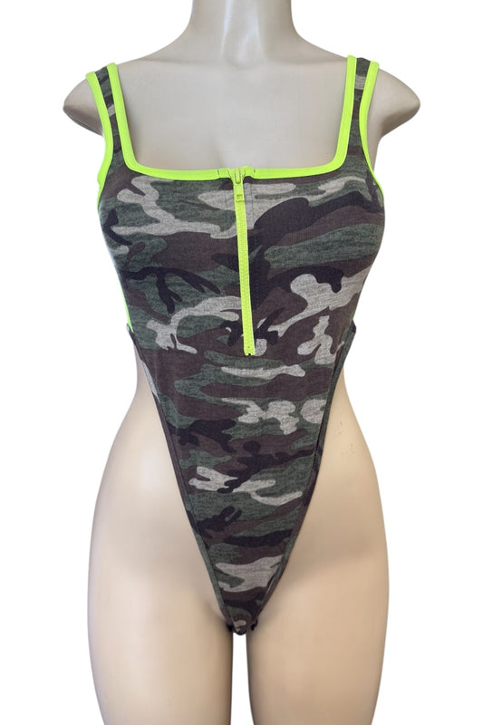 Camouflage bodysuit with neon green accents on a mannequin against a white background