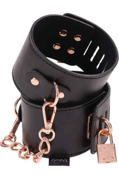 Black leather muzzle with rose gold hardware on a white background