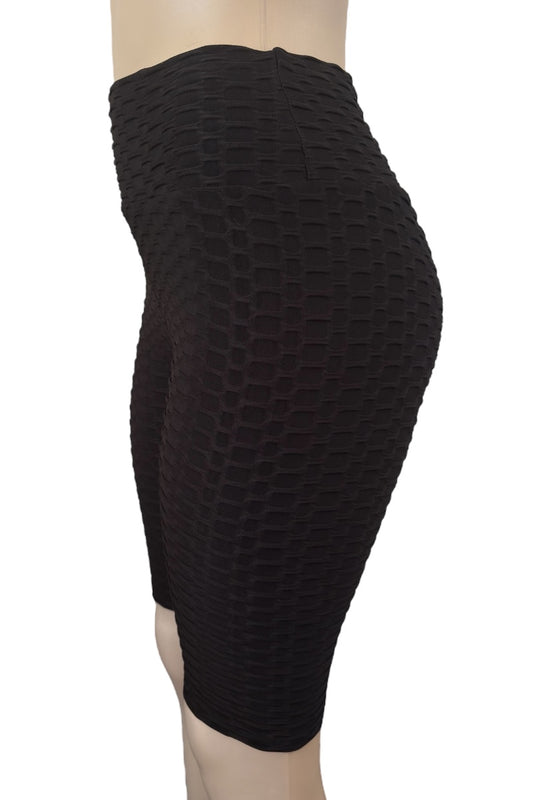 Black textured knee-length shorts on a mannequin against a white background