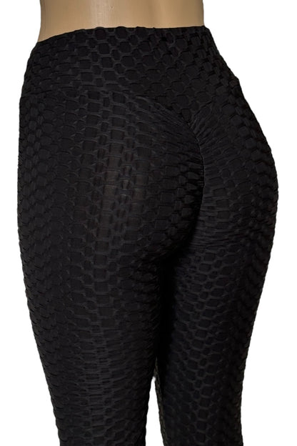 Black textured leggings on a white background