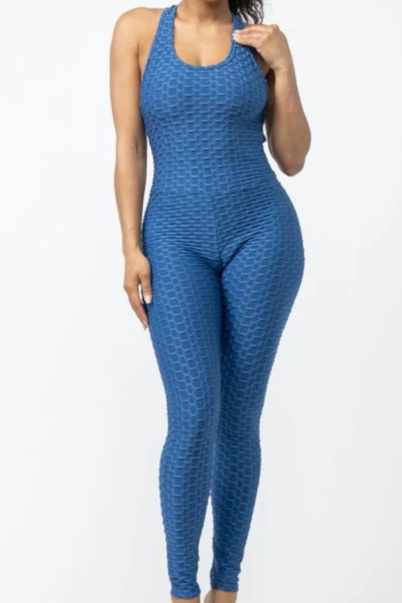 Blue patterned jumpsuit worn by a person on a white background