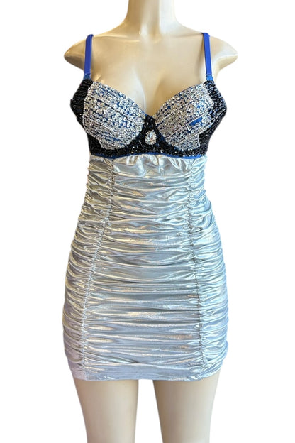 Silver dress with black embellished bra on a mannequin against a white background