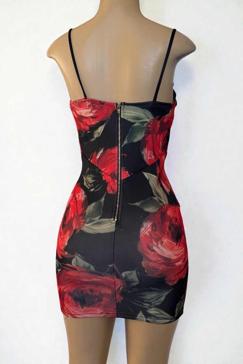 Black dress with red floral pattern on a mannequin against a white background