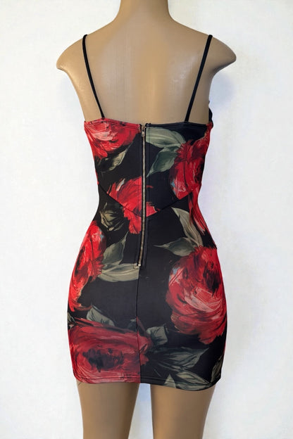 Black dress with red floral pattern on a mannequin against a white background