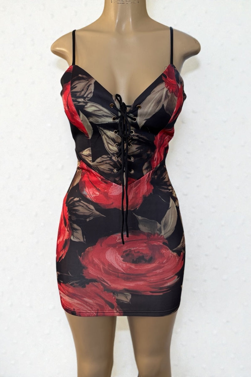 Dress with red and black floral pattern on a mannequin against a white background