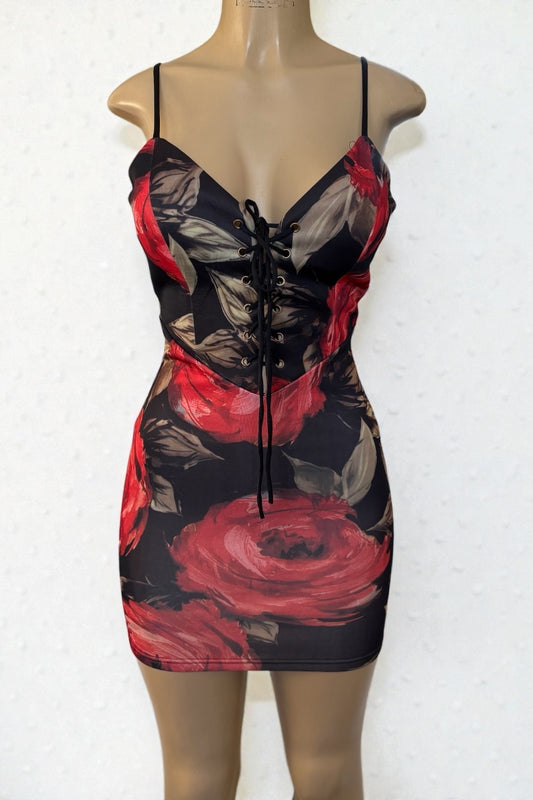 Dress with red and black floral pattern on a mannequin against a white background