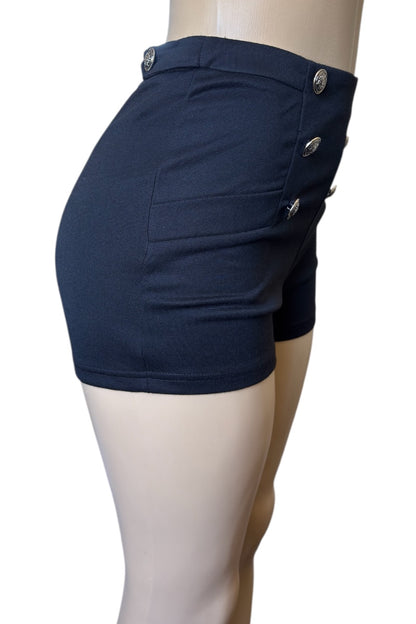 black shorts with button details on a mannequin against a white background