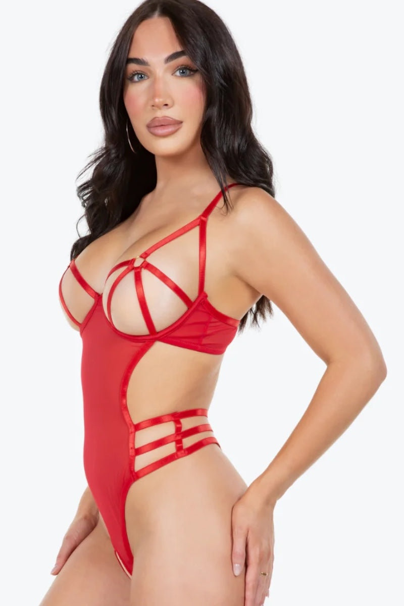 Woman wearing a red strappy bodysuit on a white background