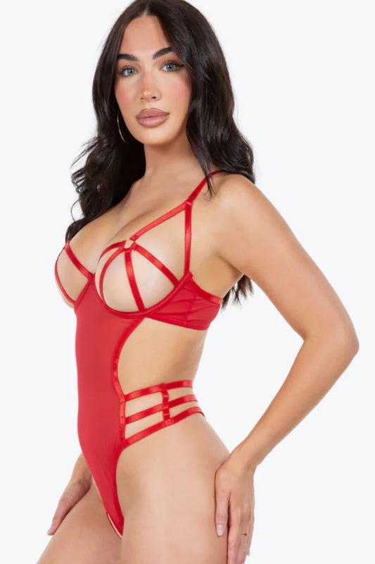 Woman wearing a red strappy bodysuit on a white background
