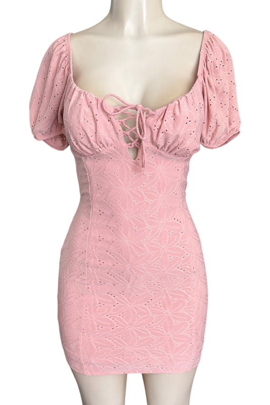 Pink lace dress on a mannequin against a white background
