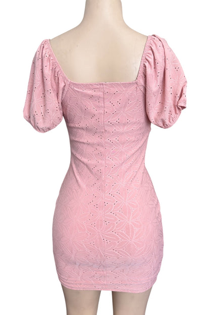 Pink dress with puff sleeves on a mannequin against a white background