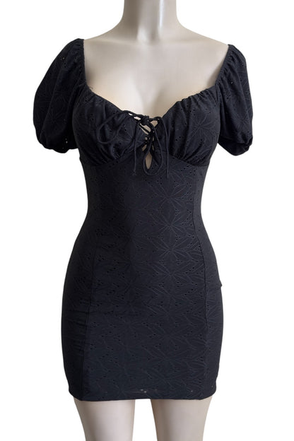 Black dress with puff sleeves on a mannequin against a white background