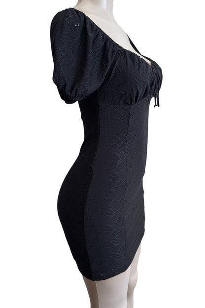 Black off-shoulder dress on a mannequin against a white background