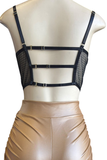 Mannequin wearing a black mesh top and brown shorts on a white background