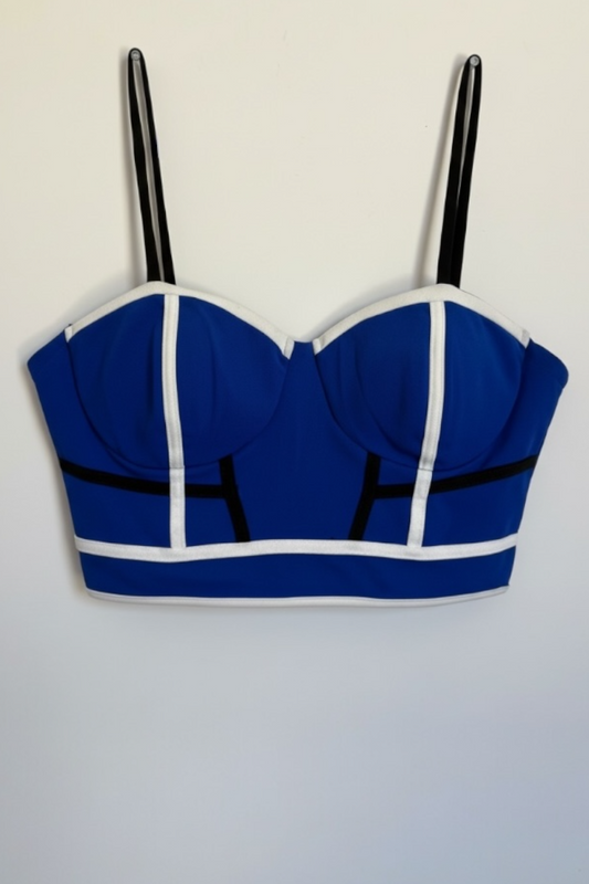 Blue crop top with black straps on a light gray background