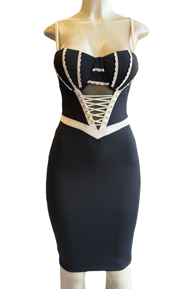 Black and beige dress on a mannequin against a white background