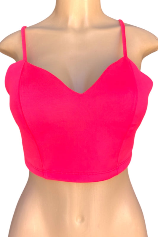 Pink crop top on a mannequin with a plain background