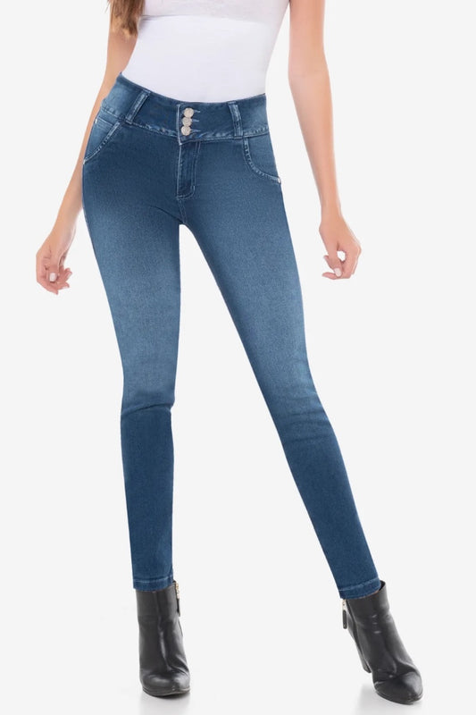 Person wearing blue jeans and black boots on a white background