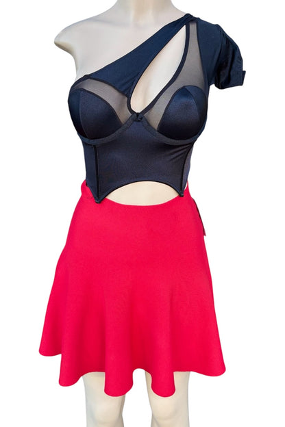 Mannequin wearing a black top with cut-out design and a red skirt on a white background