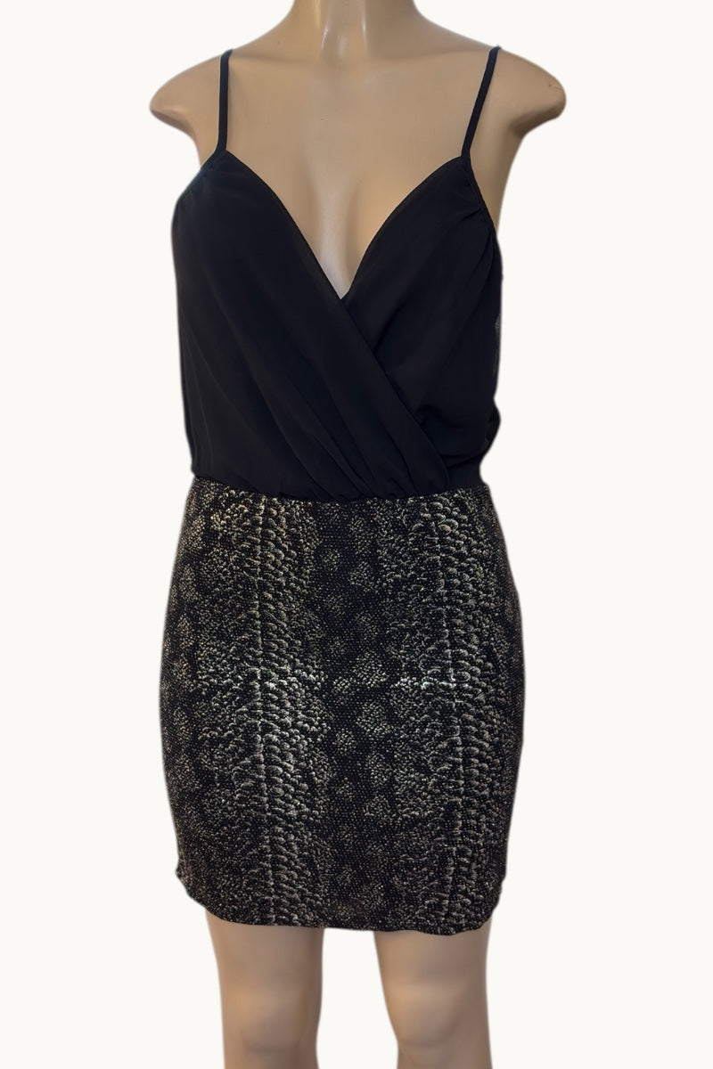 Black dress with a patterned skirt on a mannequin against a white background