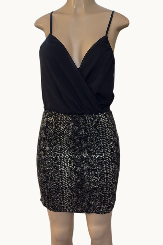 Black dress with a patterned skirt on a mannequin against a white background
