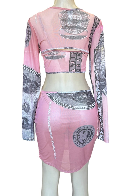 Mannequin wearing a pink dress with money print design on a white background