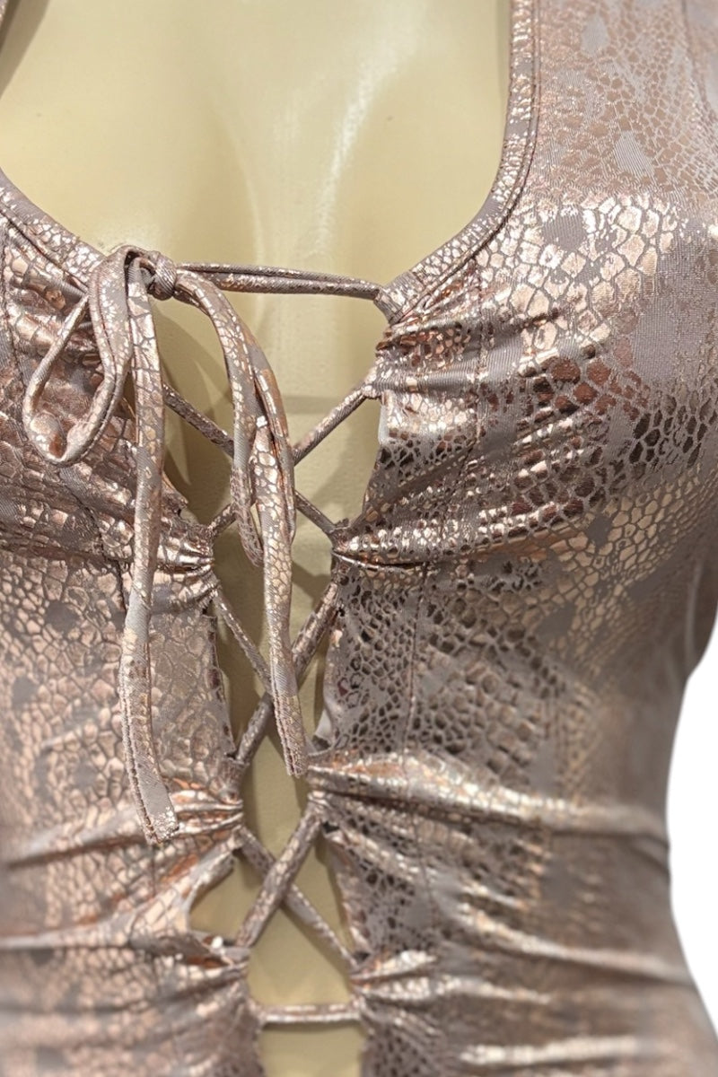 Metallic gold lace-up dress on a mannequin against a neutral background