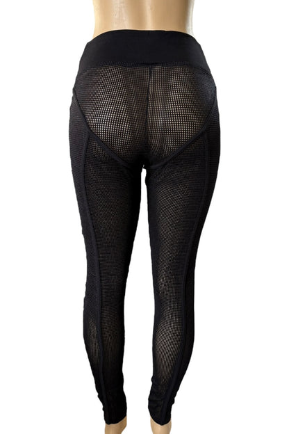 Black fishnet leggings on a mannequin against a white background