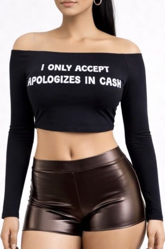 Person wearing a black off-shoulder top with text and brown shorts on a white background