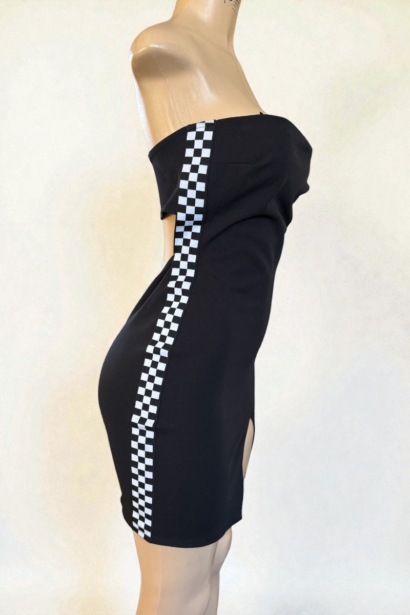 Black dress with white checkered stripe on a mannequin against a light background