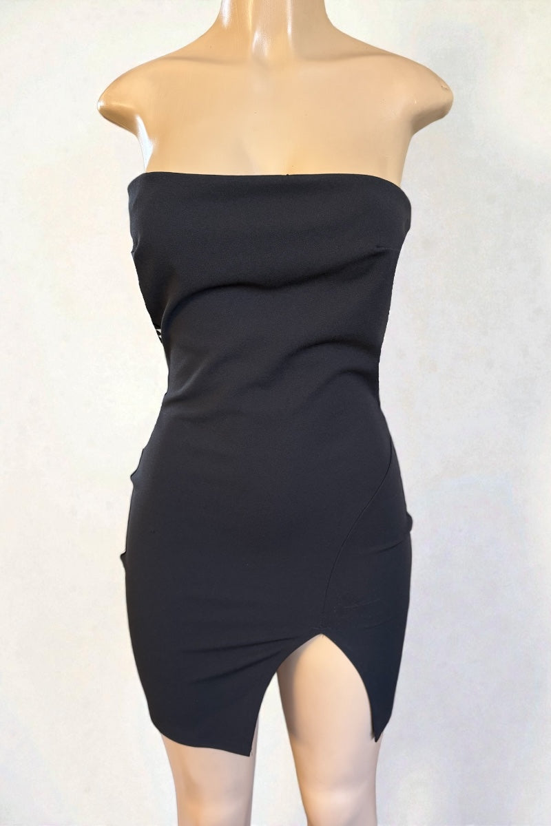 Black strapless dress on a mannequin against a white background