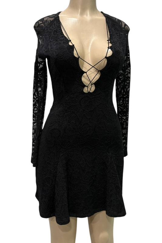 Black dress with long sleeves and lace detailing on a mannequin against a white background