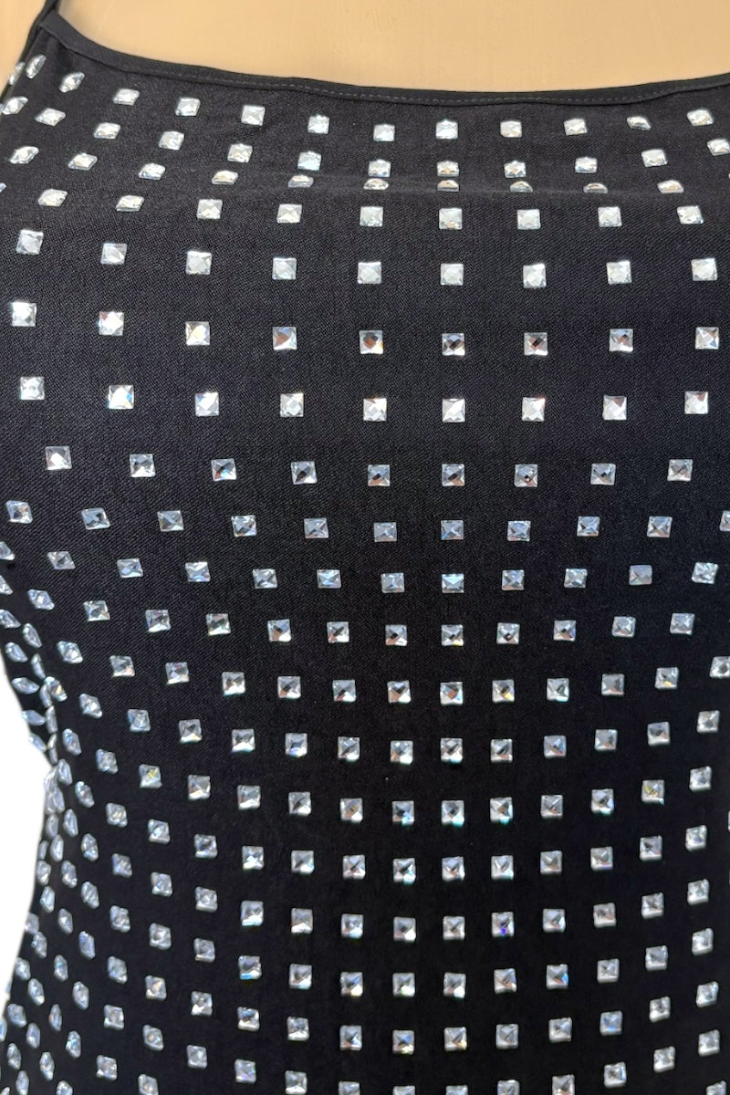 Black dress with rhinestone square patterns on a plain background