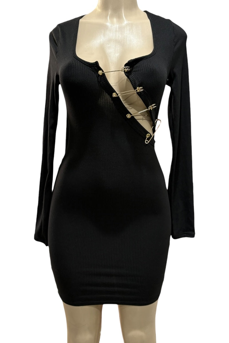 Black dress with gold pins on a mannequin against a white background
