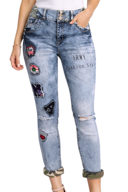Light blue jeans with patches and text on a white background