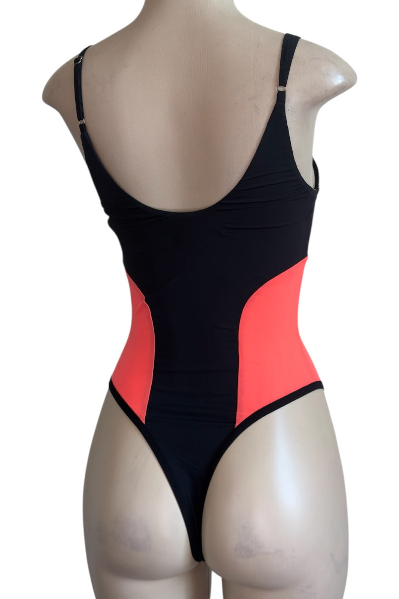 Black and orange bodysuit on a mannequin against a white background
